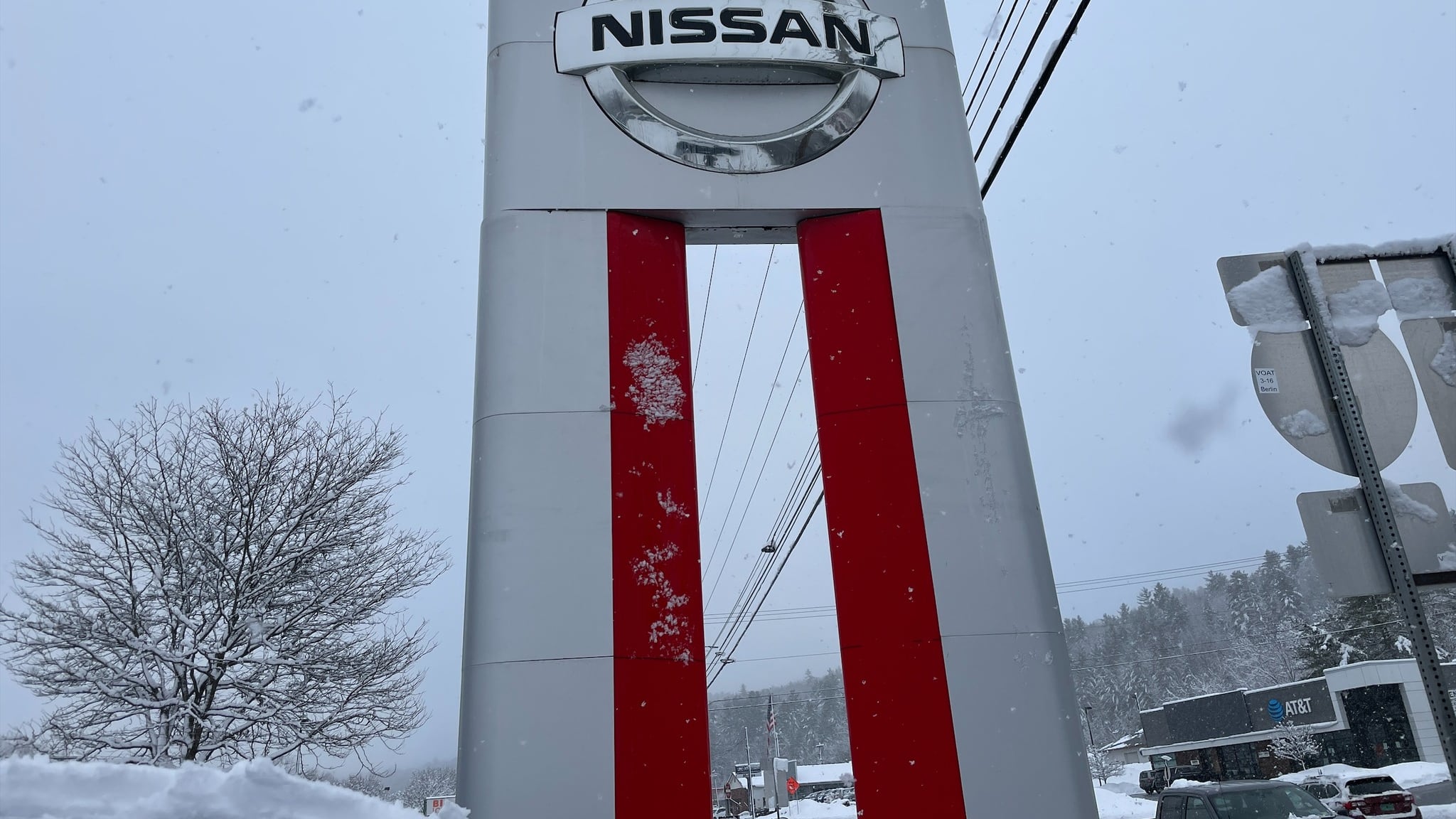 Nissan dealership sign with snow in the background.